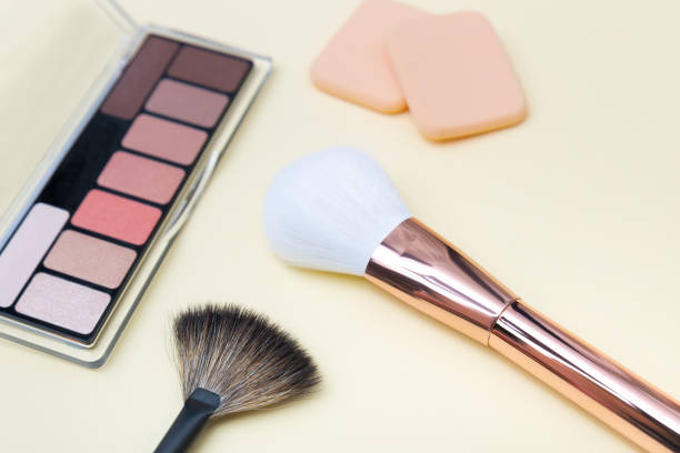 istock Decorative cosmetics, makeup products and brushes on light pink background 1142683865
