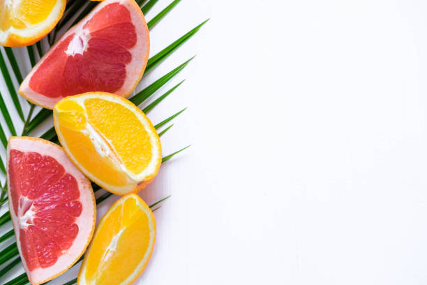 istock Template for tropical banner with palm leaf, grapefruit and orange on a white background. Frame for text with citrus. Tropical banner design over a white background. View from above 1142684741