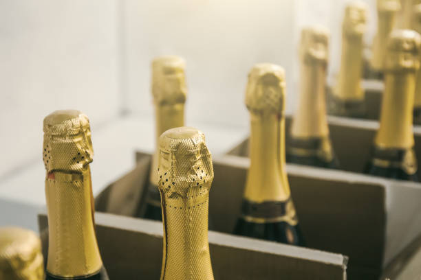 istock Champagne bottles in boxes in wine store, close up 1142686349