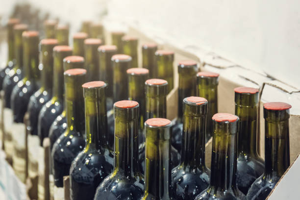 istock Rows of wine bottles in wine store, close up 1142686421