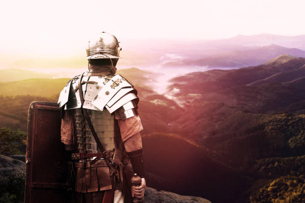 ancient Roman soldier Roman legionary watching the valley at sunset after battle day battle reenactment stock pictures, royalty-free photos & images
