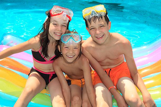 istock Three smiling children in a paddling pool 114268950