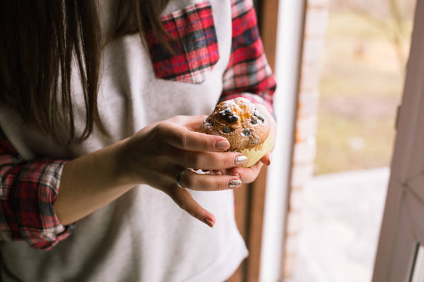istock Muffin on girl hands. Close up. 1142689677