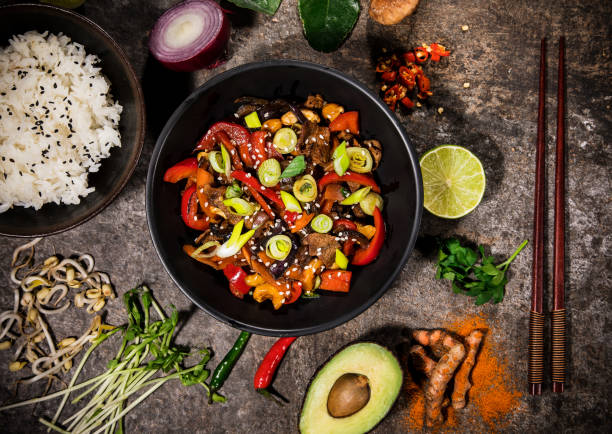 istock Szechuan beef asian food background with various ingredients on rustic stone background , top view. 1142690127