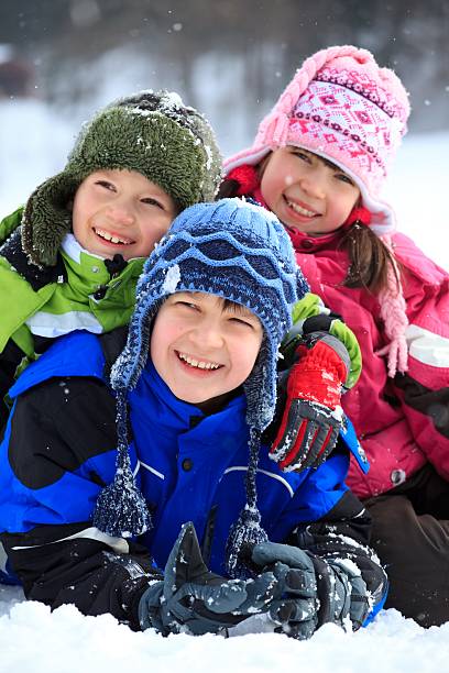 istock Happy children posing for a picture in the snowfall 114269037