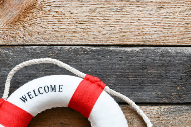 istock Lifebuoy with Welcome aboard phrase on wooden background 1142692888