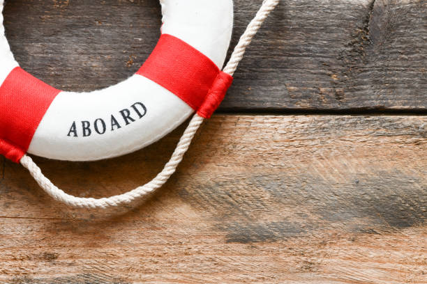 istock Lifebuoy with Welcome aboard phrase on wooden background 1142693257