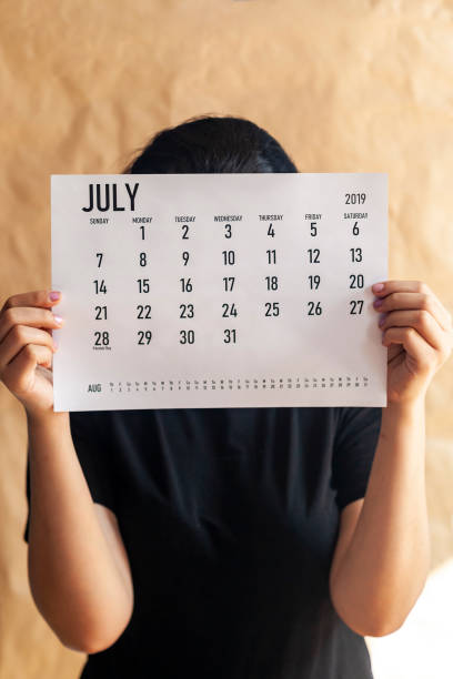 istock A woman holding simple July 2019 calendar 1142694209