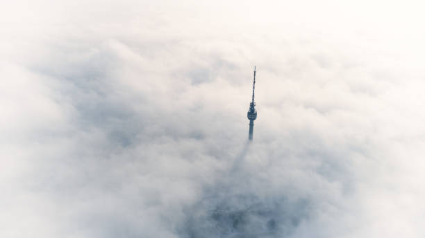 A telecommunications tower over the white sea of clouds. Drone point of view of a telecommunications tower rising over the white clouds. antenna aerial stock pictures, royalty-free photos & images
