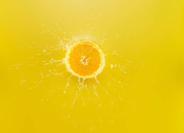 istock Slice of Orange falling into Orange juice 1142699268