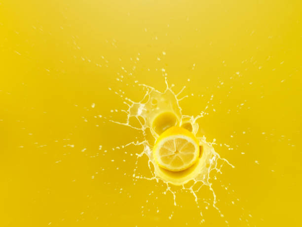 istock Slice of Lemon falling into Lemon Juice 1142699269