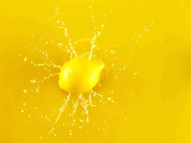 istock Slice of Lemon falling into Lemon Juice 1142699276