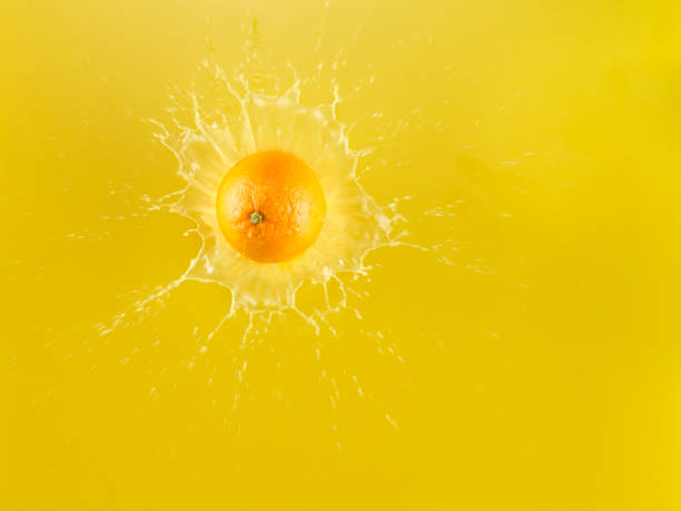istock Ripe Juicy Orange falling into orange juice 1142699279