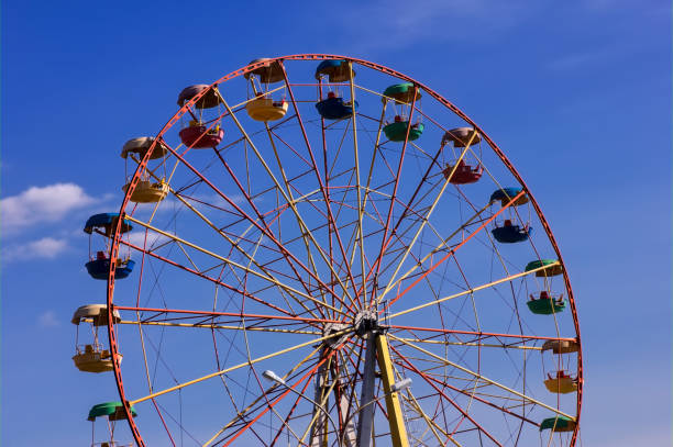 istock Ferris wheel in the park against blue sky. 1142708513