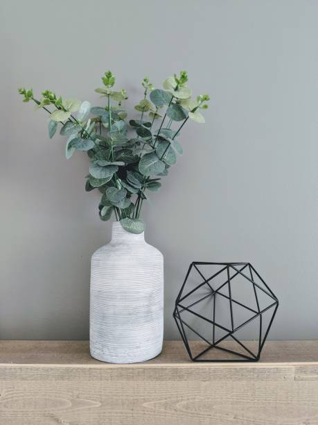 istock Eucalyptus plant in a grey vase with geometrical shape 1142712249