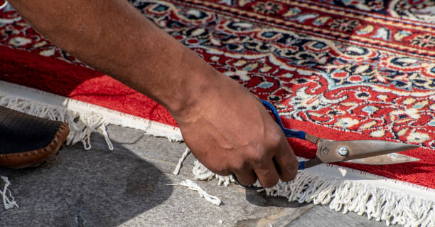 istock Scissors trim an Arabian carpet in Doha market. 1142713929