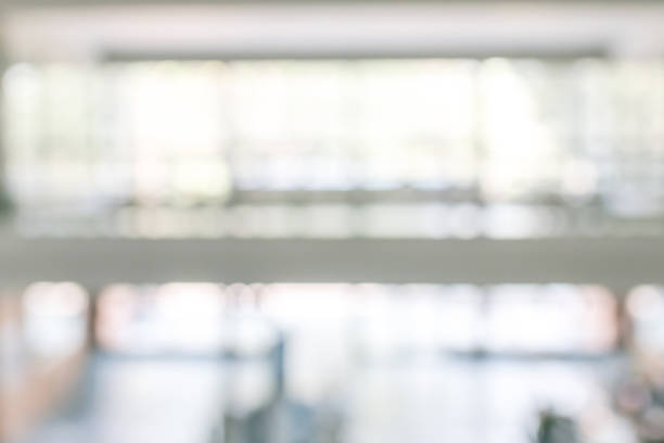 istock Business office corridor blur background interior view empty lobby hallway with glass wall white room and light bokeh 1142719362