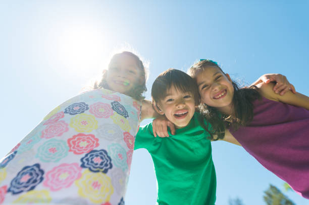istock Portrait of three elementary-age kids posing on a hot summer day 1142720086