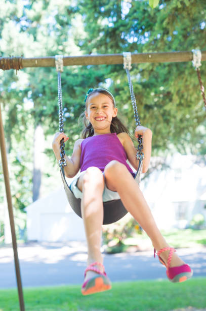 istock Girl swinging at the park 1142720113