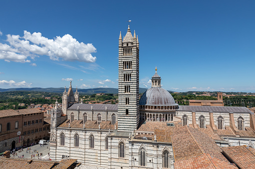 Siena, Italy - June 28, 2018: Panoramic view of exterior of Siena Cathedral (Duomo di Siena) is a medieval church in Siena, dedicated from its earliest days as a Roman Catholic Marian church