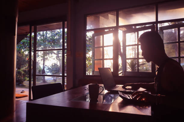 istock Asian business man working on the table with the computer and coffee sunlight 1142731486