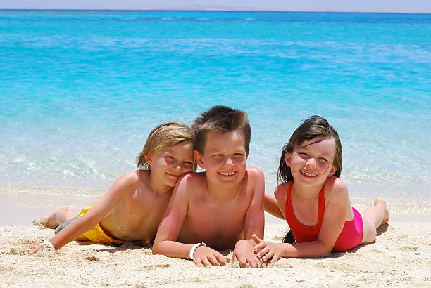 istock Happy Children Laying on Beach 114273431