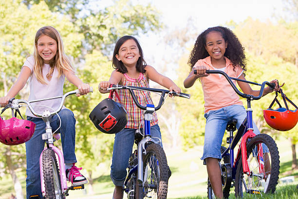 istock Three young girls outdoors on bicycles 114274108