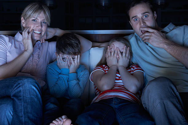 istock Family Watching Scary TV Programme Sitting On Sofa Together 114274199
