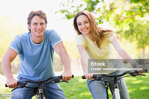 Couple On Bikes Outdoors Smiling Stock Photo - Download Image Now - 20-29 Years, 30-39 Years, Adult
