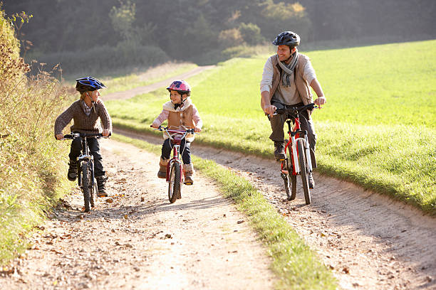 istock Young father with children riding bikes in park 114274269