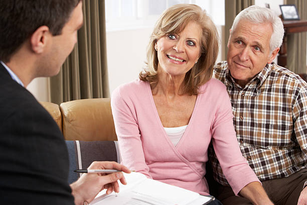 istock Senior Couple Talking With Financial Advisor 114274347