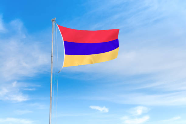 istock Armenia flag over blue sky background 1142743778