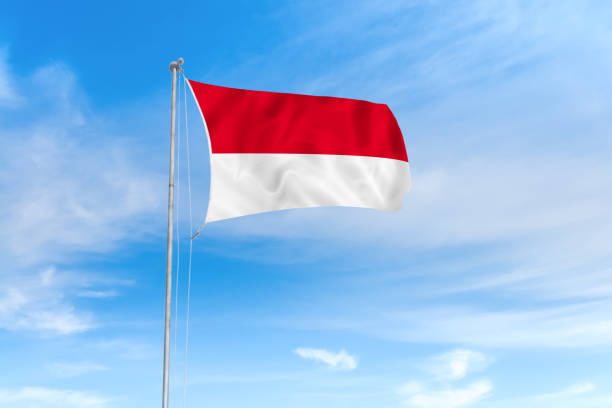istock Indonesia flag over blue sky background 1142743818