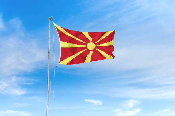 North Macedonia flag over blue sky background North Macedonia flag blowing in the wind over nice blue sky background north macedonia stock pictures, royalty-free photos & images