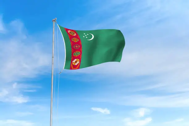 Photo of Turkmenistan flag over blue sky background