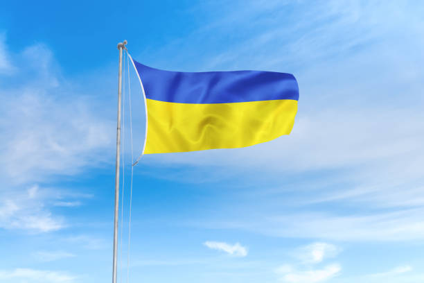 istock Ukraine flag over blue sky background 1142744383