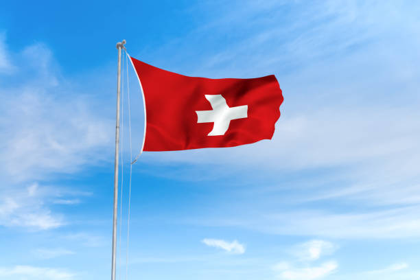 istock Switzerland flag over blue sky background 1142744385