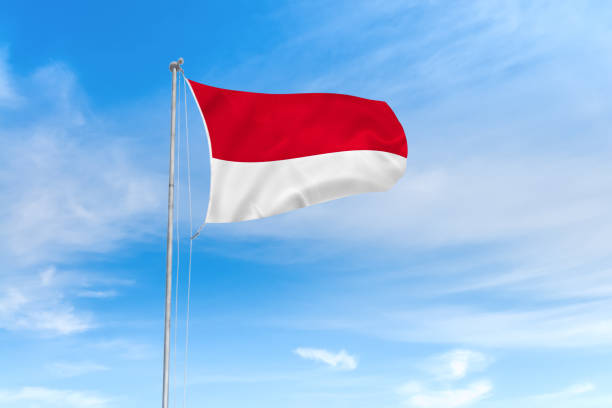 istock Indonesia flag over blue sky background 1142744454