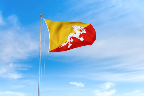 bhutan flagge über blauem himmel hintergrund - bhutanese flag stock-fotos und bilder