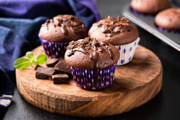 istock Chocolate muffins on wooden serving board 1142744802