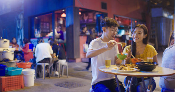 istock Young couple enjoying street food 1142747607