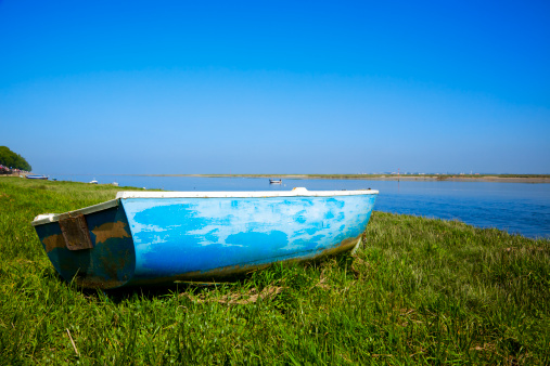 small boat laying on the grass at the shore of river Somme, Normandy, France