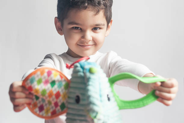 5 years adorable little kid boy playing with plush elephant toy