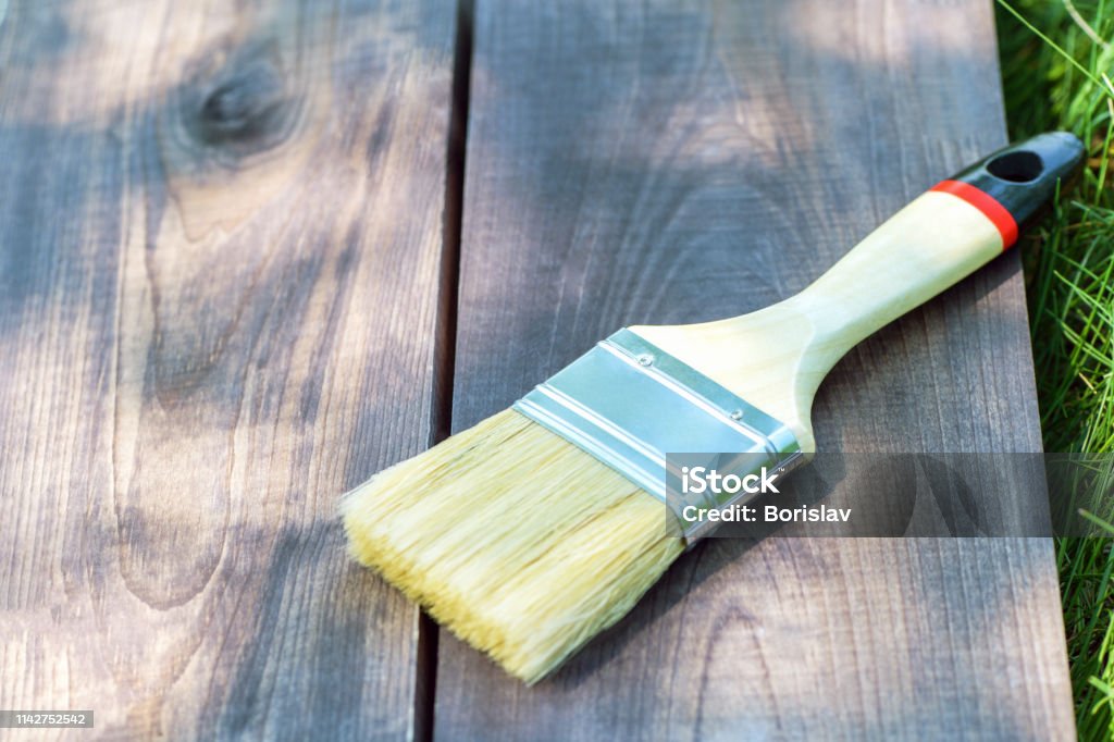 A Wide Paint Brush Lies On A Wooden Board On The Green Grass In The Street  Closeup Paint Brush On Wooden Background Stock Photo - Download Image Now -  iStock