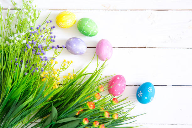 istock Easter eggs and branch with flowers on wooden 1142753053