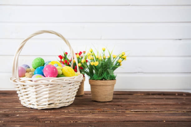 istock Easter eggs in basket on shelf in front of wooden wall. View with copy space 1142753867