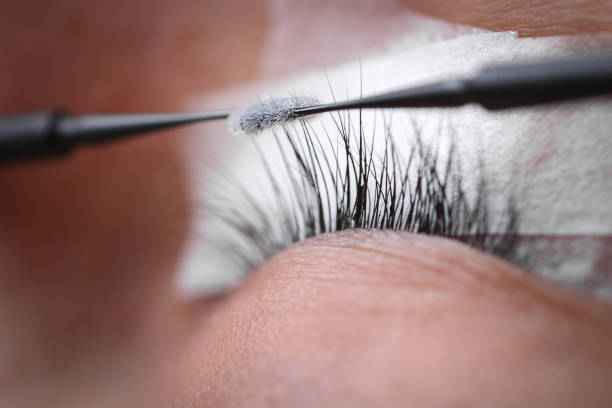istock Eyelash extension procedure, woman eye with Long eyelashes 1142755113