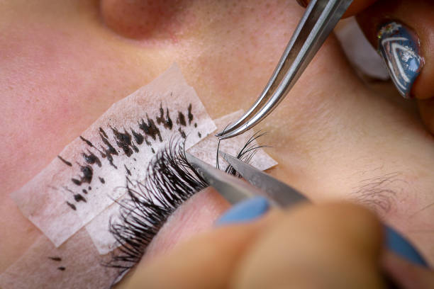 istock Eyelash extension procedure, woman eye with Long eyelashes 1142755183