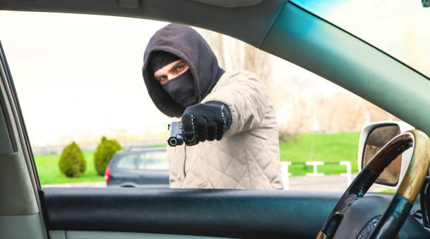 istock a thief with a gun threatens the driver 1142757009