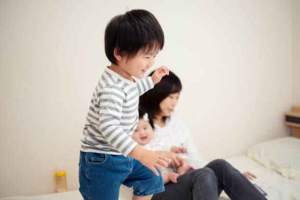 istock Little boy jumping on the bed 1142759020